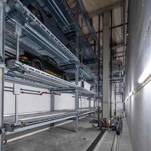 The car is parked in a shelving system
