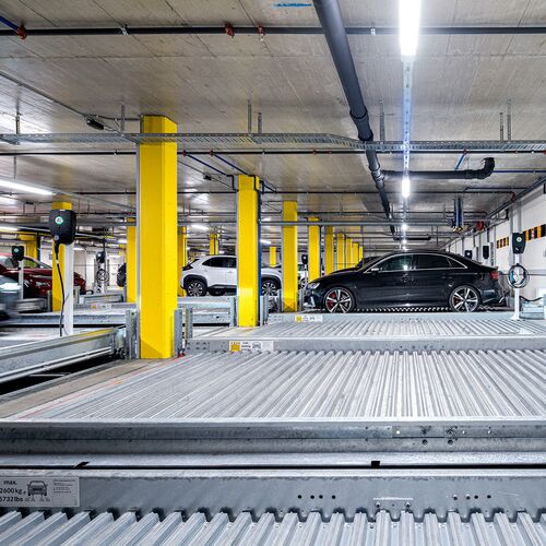 Front view of the parking systems with a car pulling in