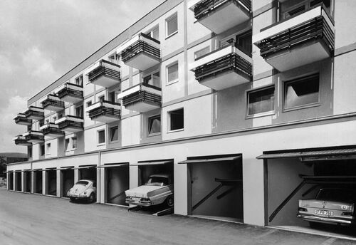 A photo of a house with open garages fitted with parking systems