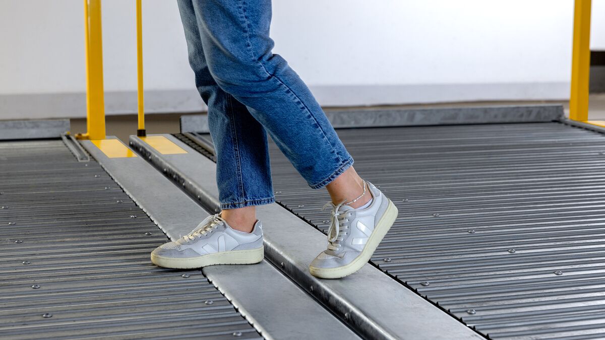 A person walks across two parking platforms