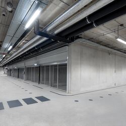 Moderne Tiefgarage mit Kreuzungsbereich, durchgehenden Fahrwegen und beidseitig angeordneten Parksystemen