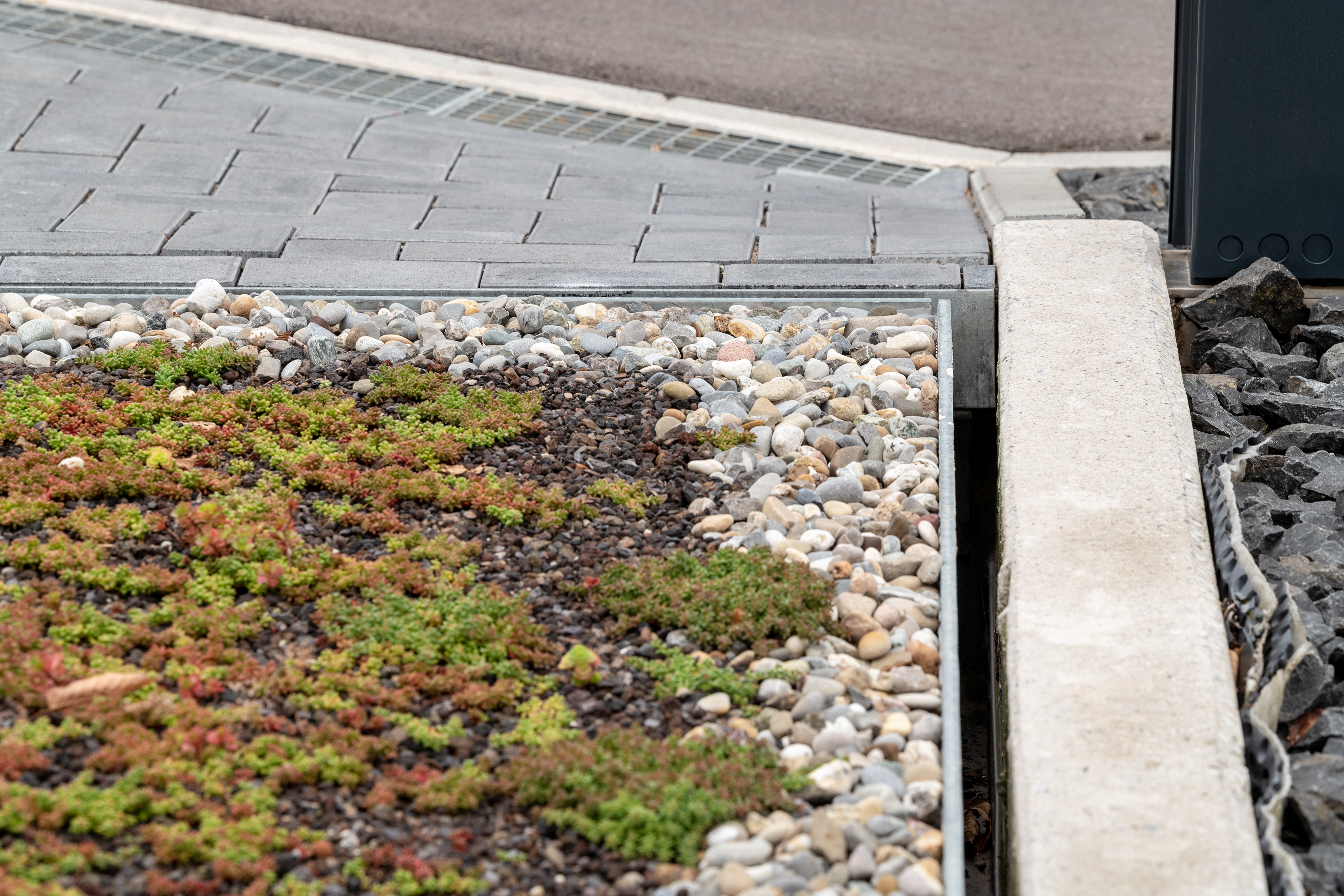 Surface of a parking system featuring grass and stones