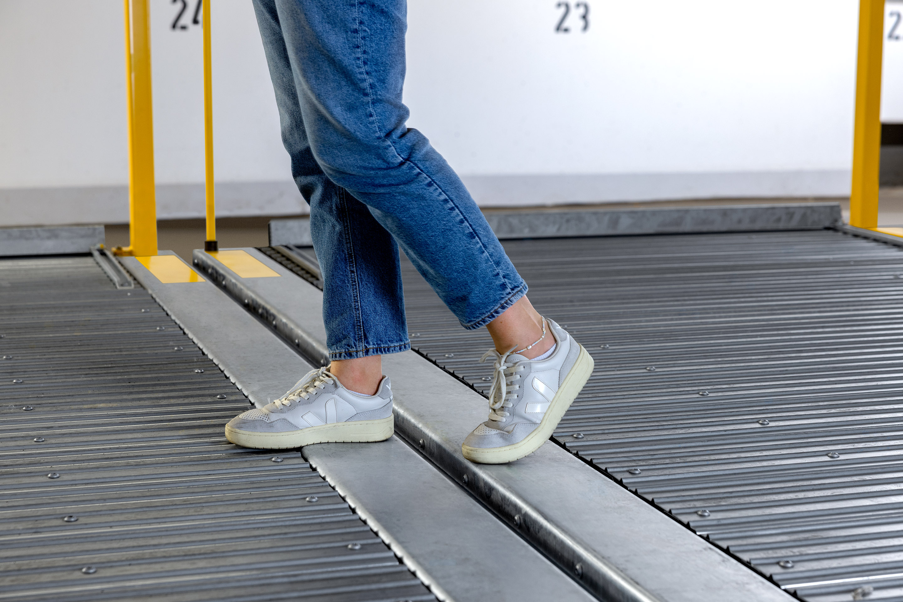 A person walks across two parking platforms