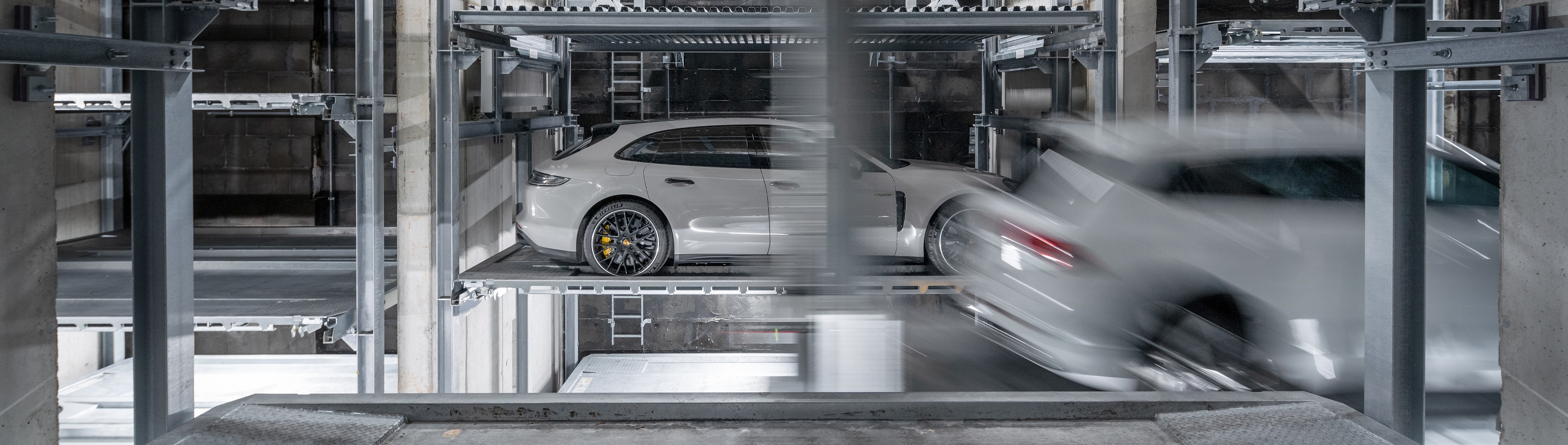 The car is moved onto a pallet in a fully automated parking system